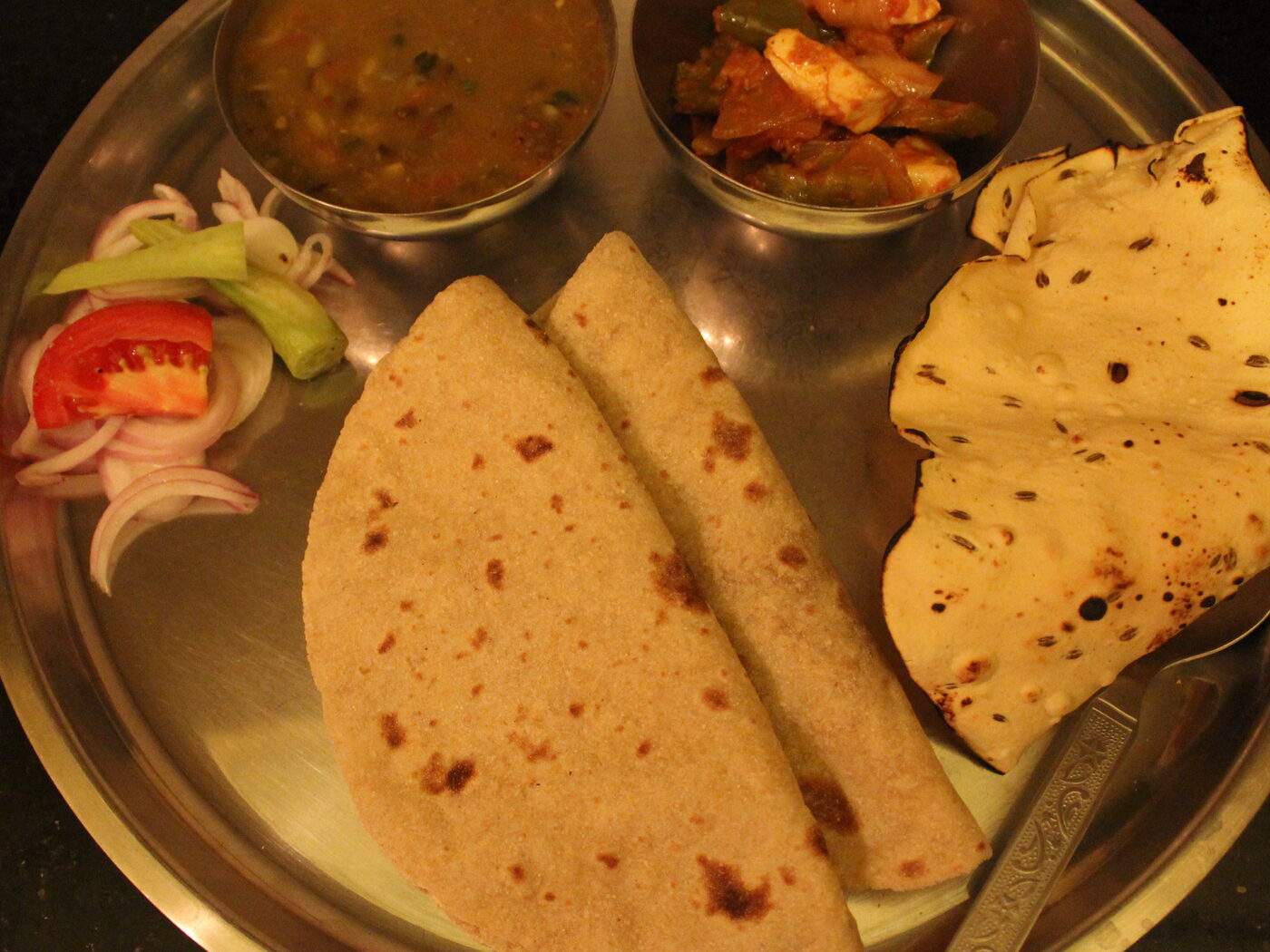 Full Punjabi thali with curries, roti, salad and papad