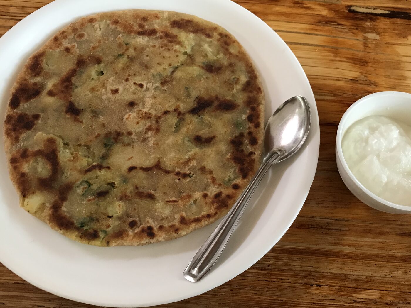 Homemade aloo paratha served with fresh dahi, Punjabi style